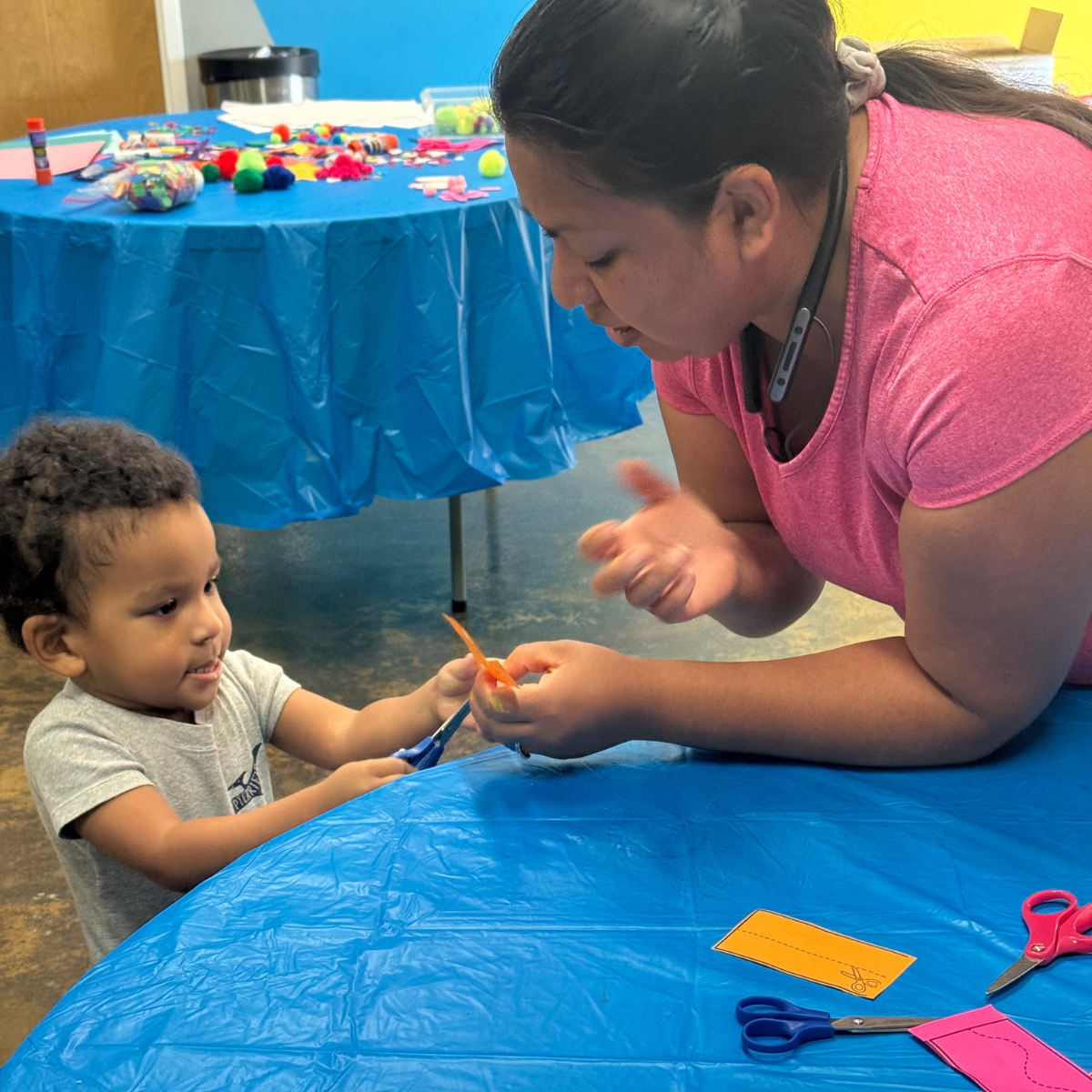 Home page Get Involved CTA - woman helping child cut with sissors