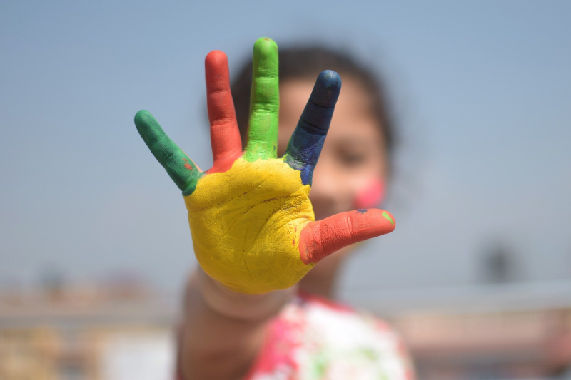 Child's hand covered in paint