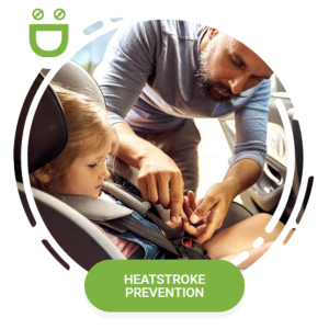 Heatstroke prevention: father buckling child in a carseat