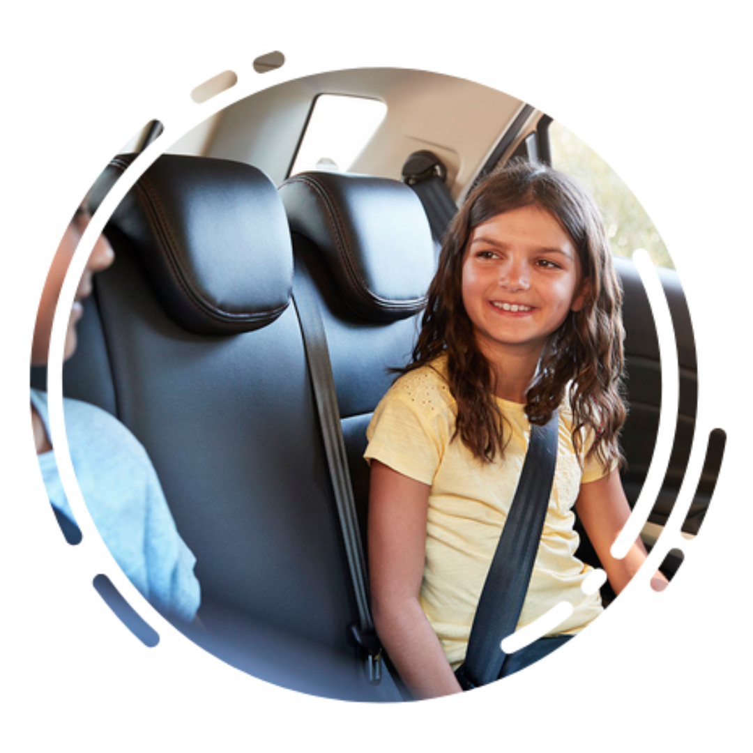 car safety: older girl child with a shoulder belt on