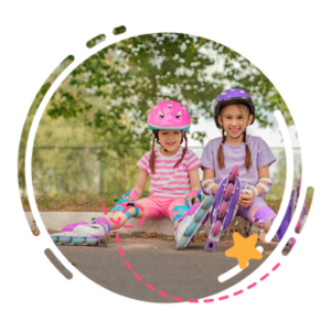 Skating and skateboarding safety tips: two young girls sitting on the ground while wearing roller blades